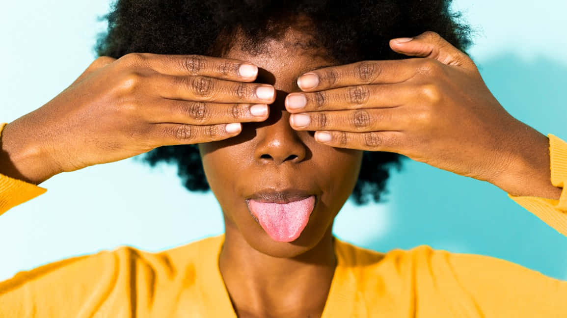 Woman Covering Eyes Tongue Out Wallpaper