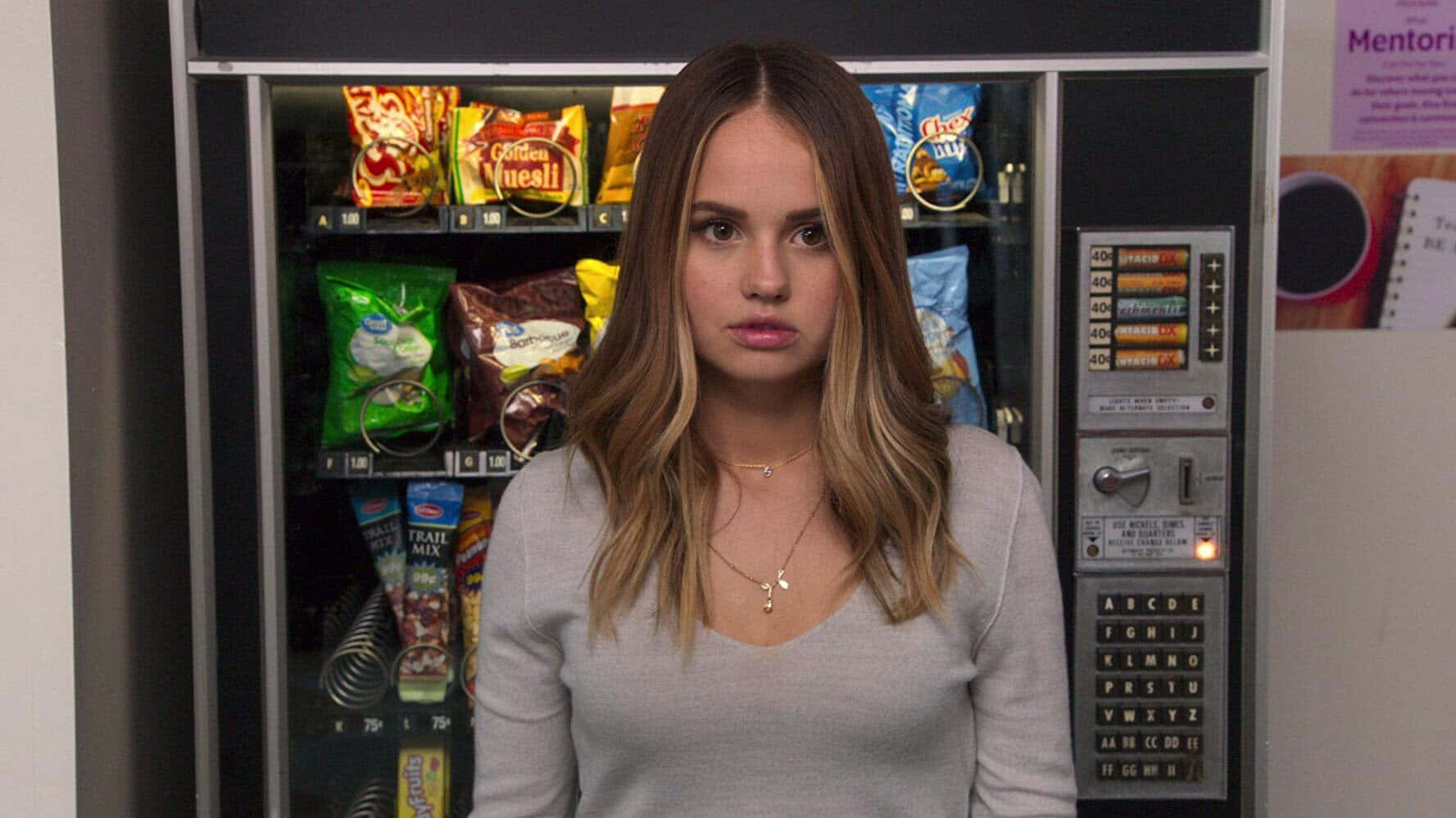 Woman Standing In Front Of Vending Machine Wallpaper