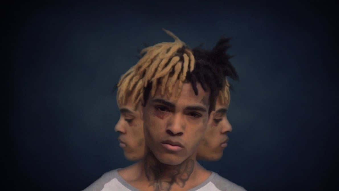 Xxxtentacion Working On His Laptop Wallpaper
