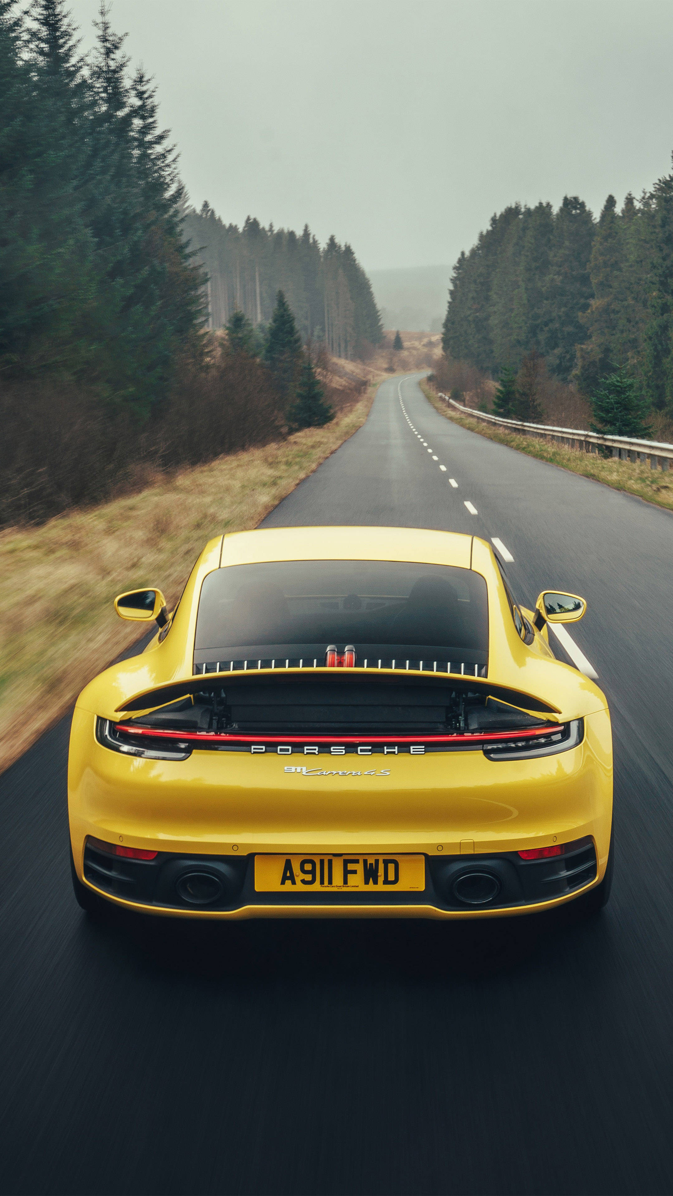 Yellow Porsche 911 Surrounded By Trees Wallpaper