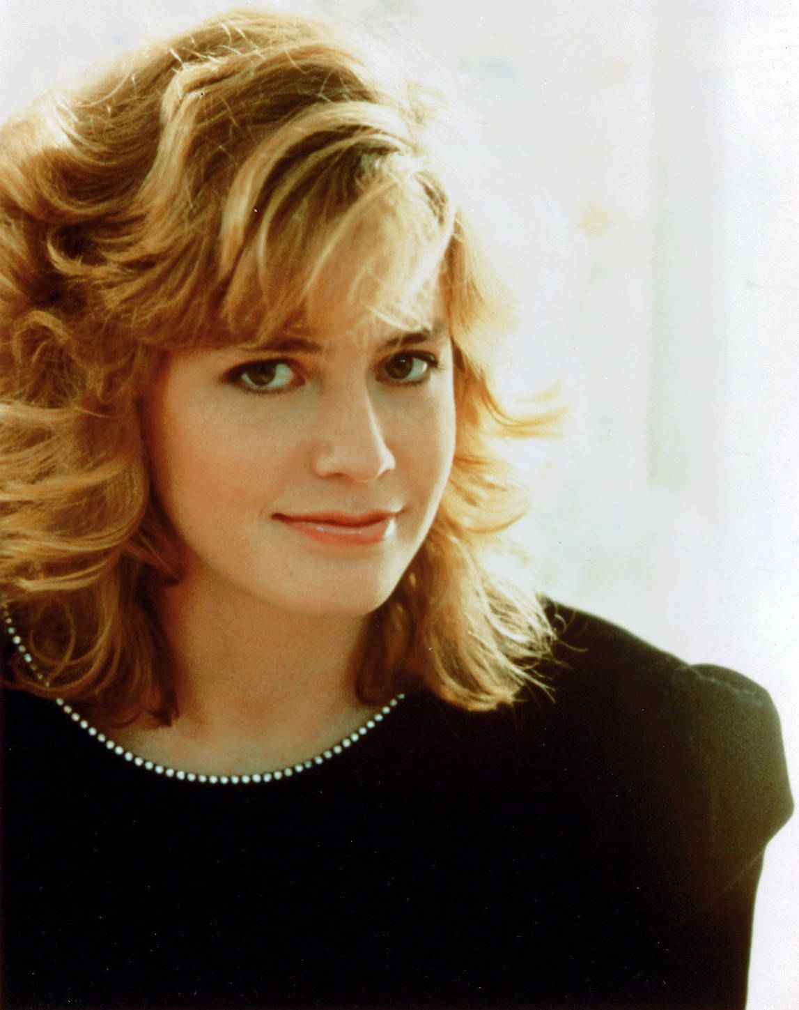 Young Elisabeth Shue Wearing Black Puffed Sleeve Top With Side Bangs Wallpaper