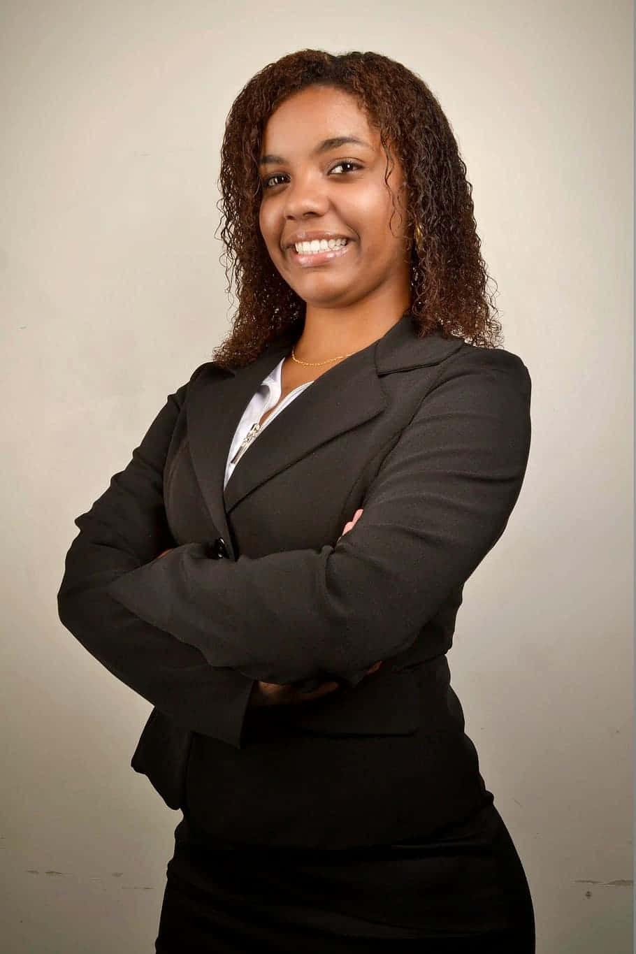 Young Professional Black Woman Dressed In Business Attire Wallpaper