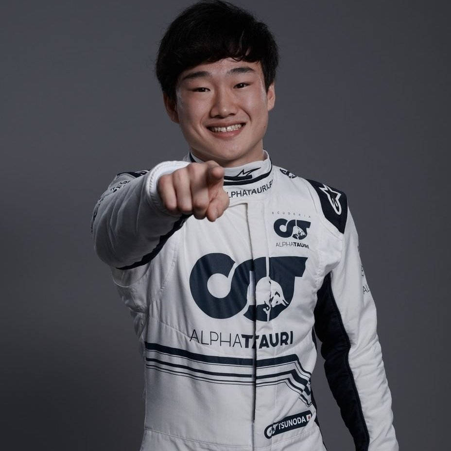 Yuki Tsunoda, Formula One Rising Star, Smiling And Pointing Forward Wallpaper