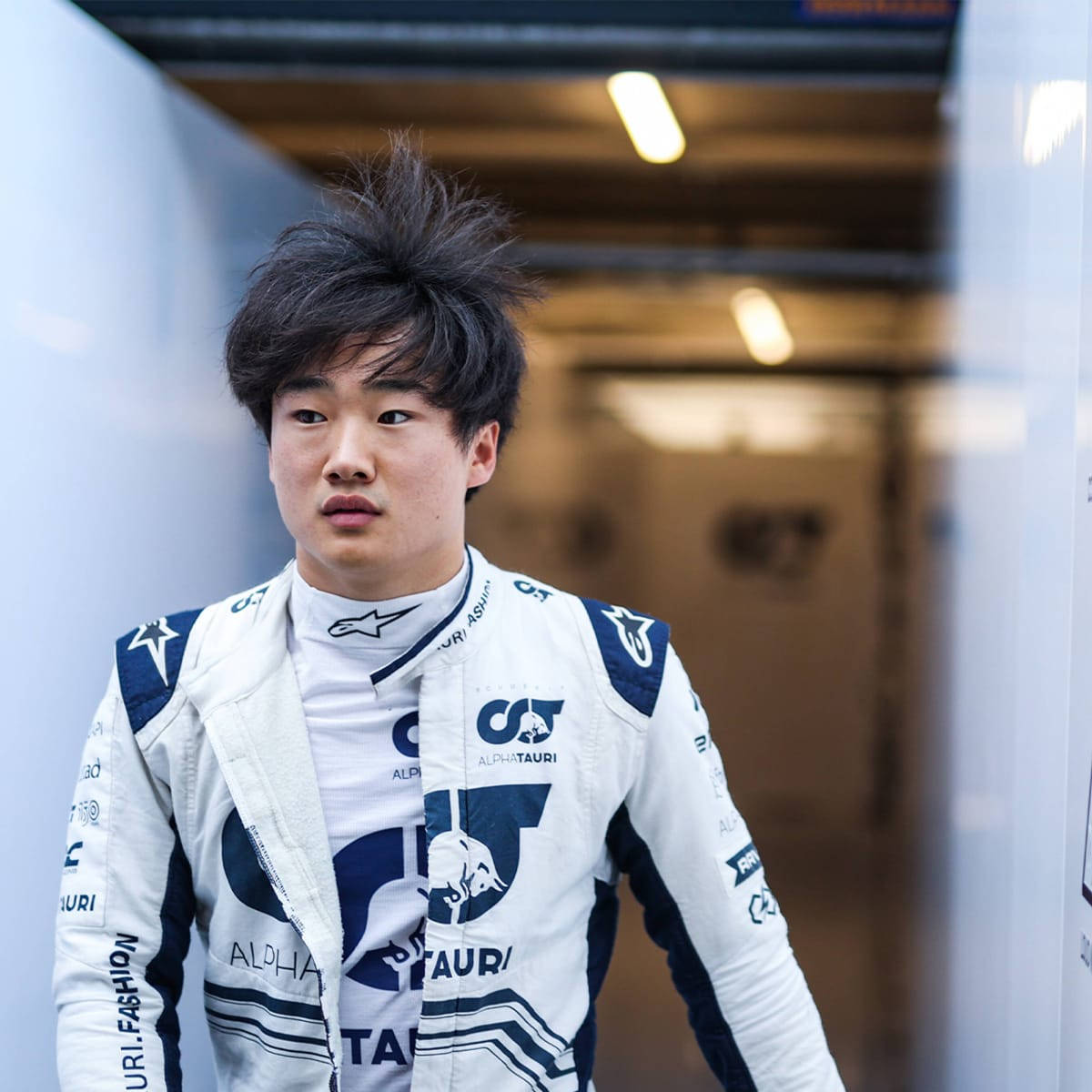Yuki Tsunoda Racing Through A Tunnel During A Grand Prix Event. Wallpaper