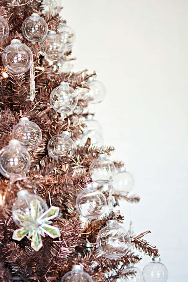 A Beautiful, Snow-covered Aesthetic Christmas Tree Standing Tall In A Winter Landscape Wallpaper