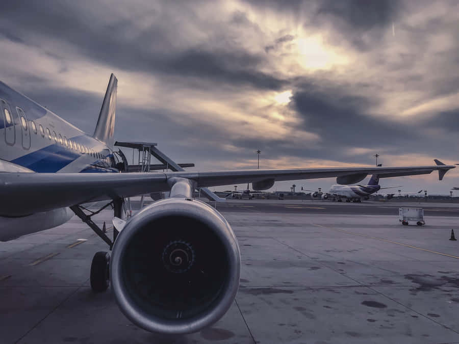 A Beautiful, Young Plane Flying Silently Under The Clouds. Wallpaper