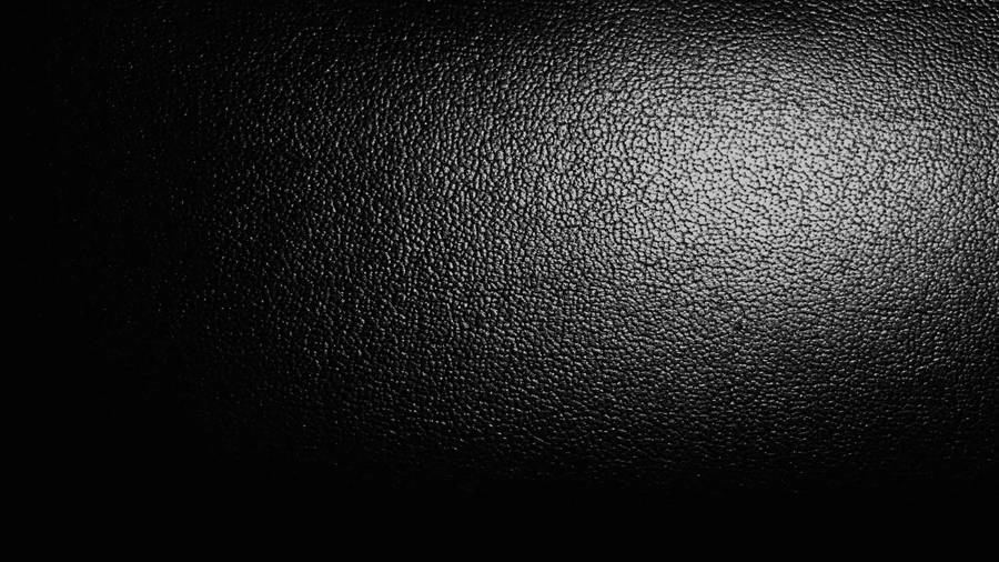 A Black Background With A Light Shining On It Wallpaper