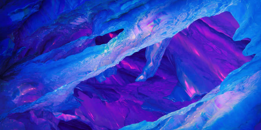 A Breathtaking View Of The Sun Setting Behind A Majestic Range Of Mountains And Lakes, Surrounded With Purples, Blues, And Subtle Hints Of Yellow. Wallpaper