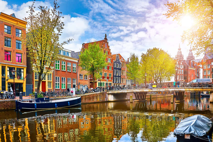 A Canal With Boats Parked In It Wallpaper