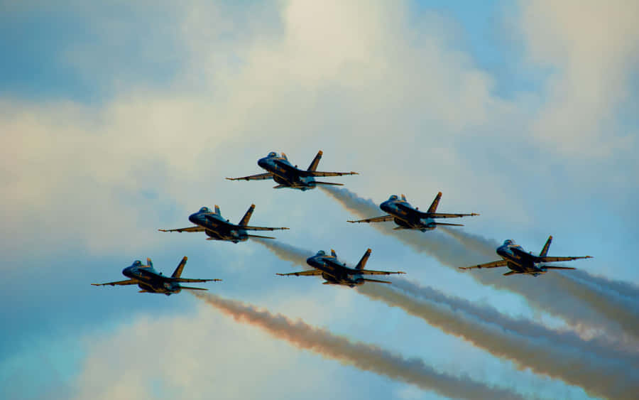 A Group Of Jets Flying In The Sky Wallpaper