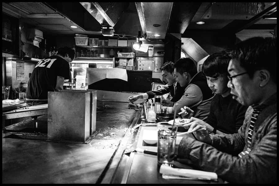A Group Of People At A Bar Wallpaper