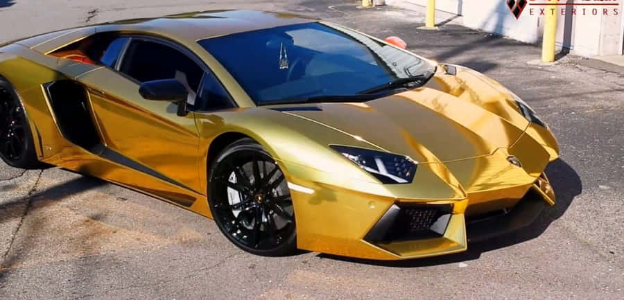 A Luxurious Golden Lamborghini In The Sunset Wallpaper