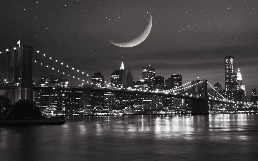 A Majestic Capture Of New York City Under The Starry Night Sky In Black And White Wallpaper