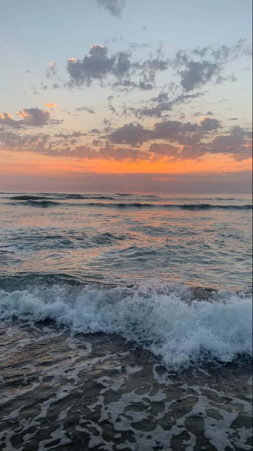 A Majestic View Of The Ocean At Sunrise. Wallpaper