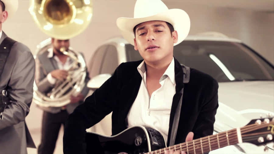 A Man In A Cowboy Hat Plays An Acoustic Guitar Wallpaper