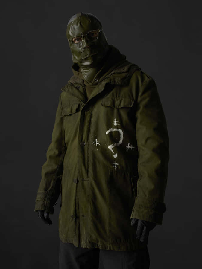 A Man In A Green Jacket And A Mask Wallpaper