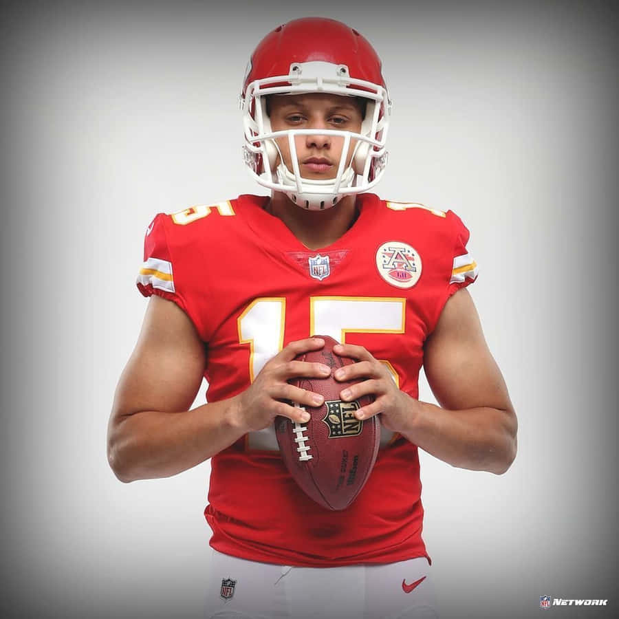 A Man In A Red Uniform Holding A Football Wallpaper