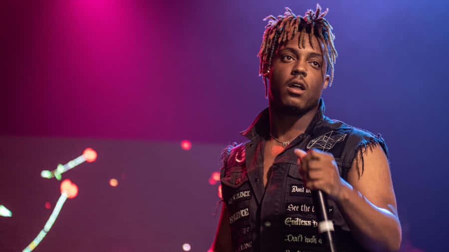 A Man With Dreadlocks Is Holding A Microphone Wallpaper