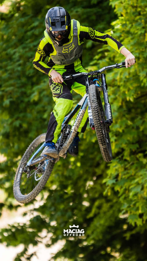 A Person Riding A Mountain Bike In The Air Wallpaper