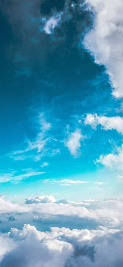 A Plane Flying Over The Clouds Wallpaper