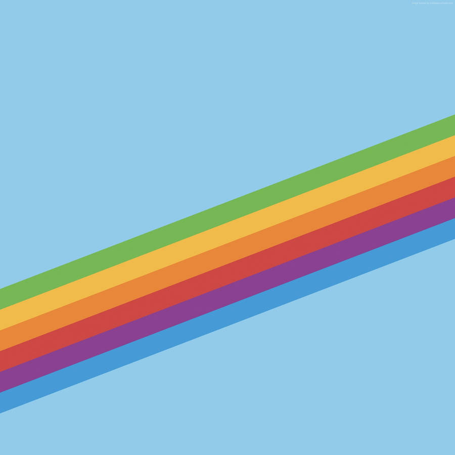 A Rainbow Of Color Emerges Against A Blue Sky Wallpaper