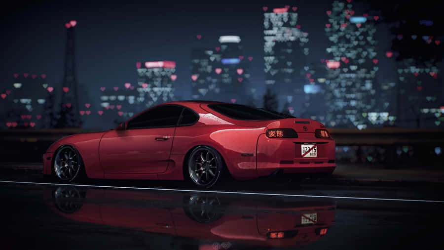 A Red Sports Car Sitting On A Street At Night Wallpaper
