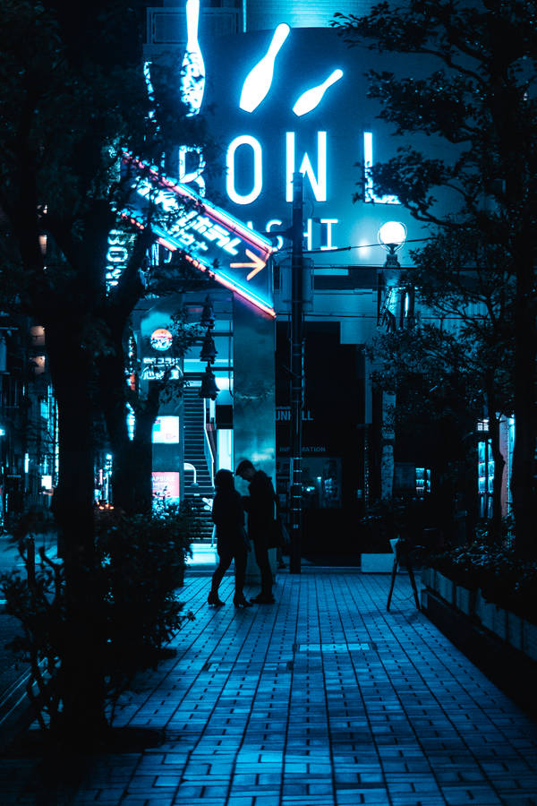 A Romantic Couple In The Glowing Blue City Wallpaper