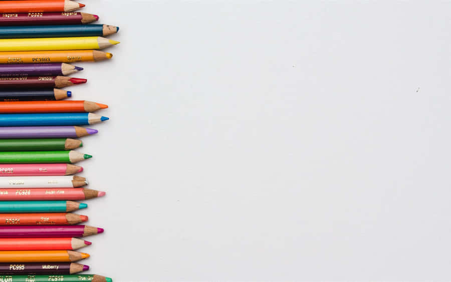 A Row Of Colored Pencils On A White Background Wallpaper