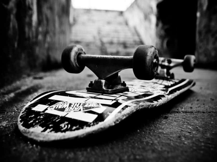 A Skateboard Is Laying On The Ground Wallpaper