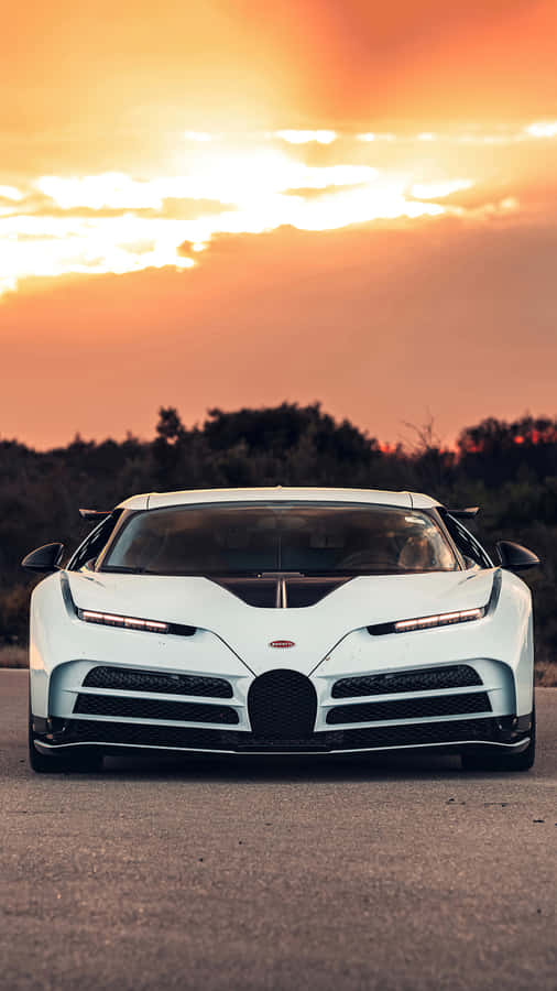 A White Bugatti Chiron Sitting On The Road At Sunset Wallpaper
