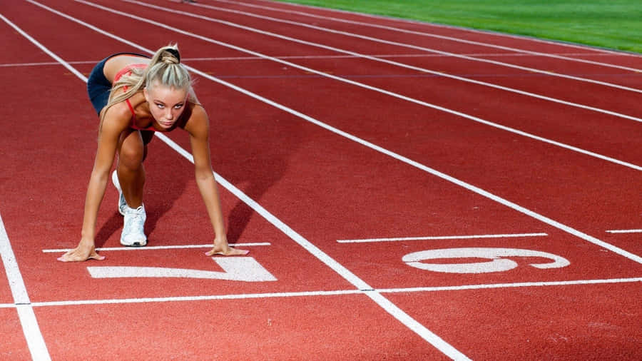 A Woman Is Preparing To Run On A Track Wallpaper
