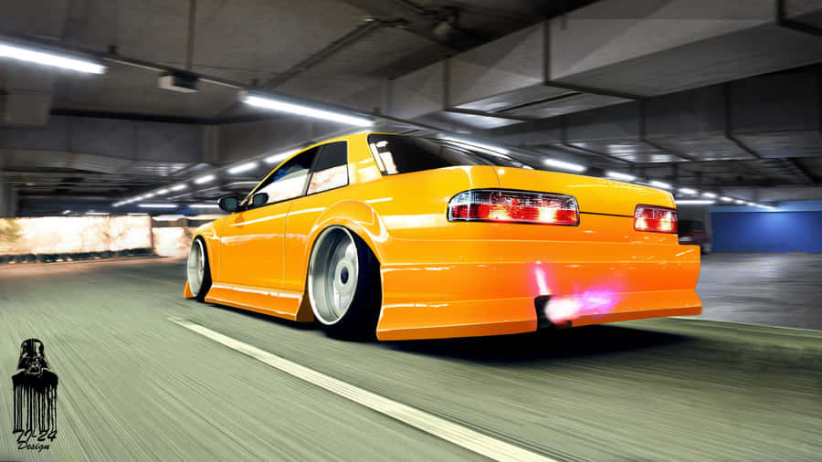 A Yellow Car Driving Down A Street Wallpaper