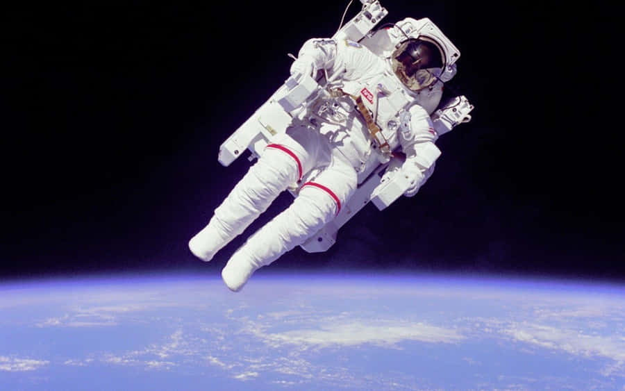 A Young Astronaut Explores The Vastness Of Space Wallpaper