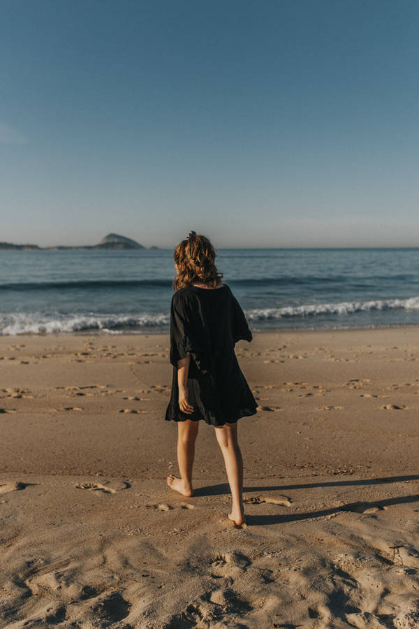 Aesthetic Beach Woman On The Shore Wallpaper
