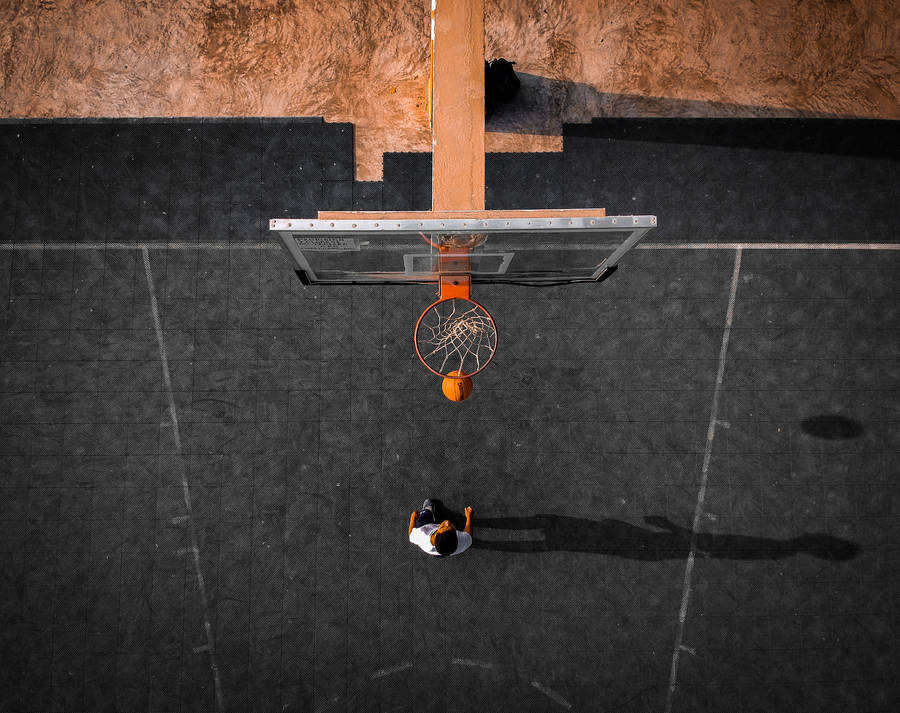 An Action Packed View Of A Basketball Hoop Wallpaper