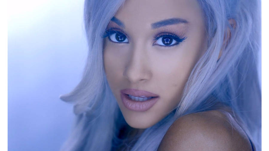 Ariana Grande Singing In A Colorful Spotlight. Wallpaper