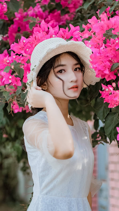 Asian Women Posing By The Flowers Wallpaper