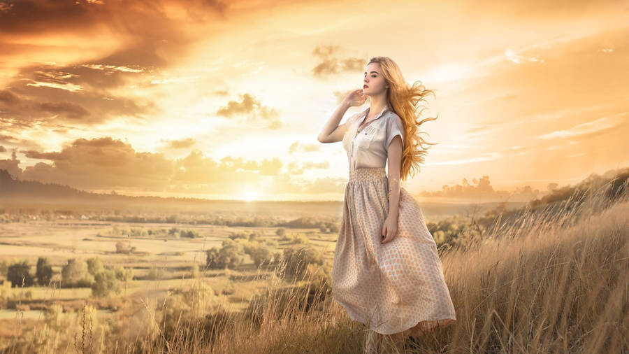 Beautiful Blonde In Scenic Grassy Field Wallpaper