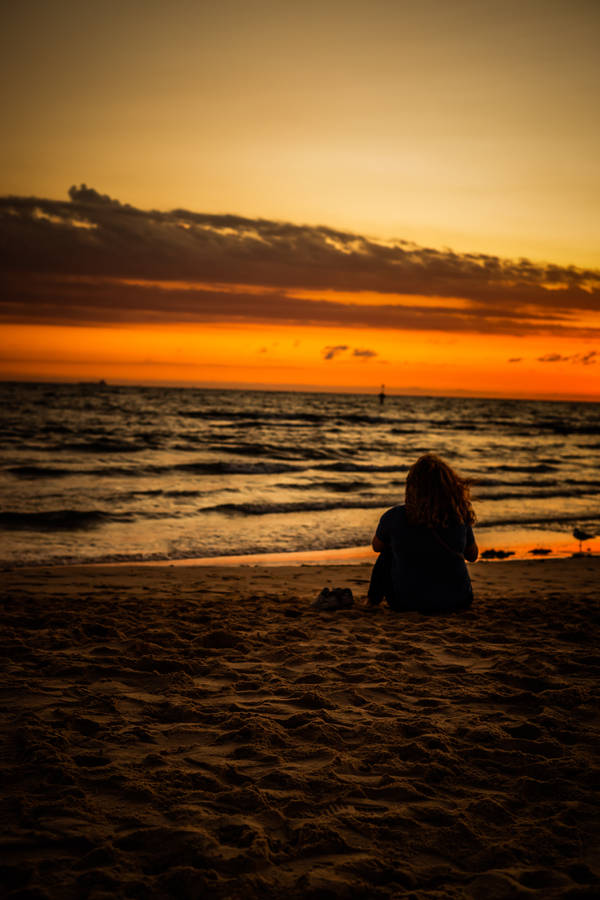Blissful Woman Enjoying A Summer Day At The Beach Wallpaper