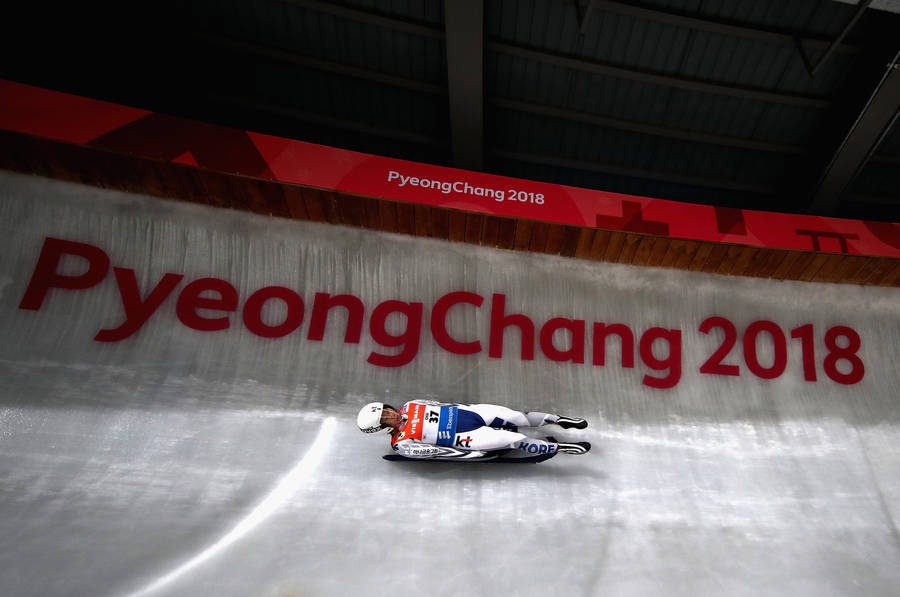 Breakneck Speed - A Luge Athlete In Action Wallpaper