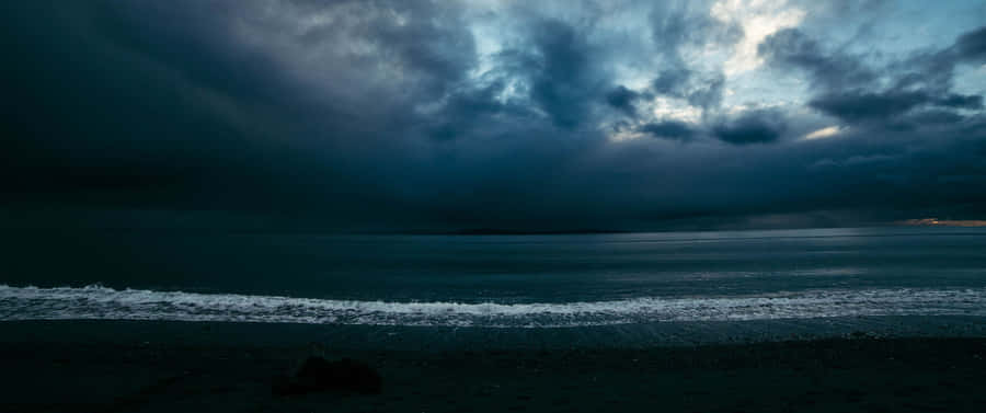 Calm But Cloudy Beach Oled Monitor Wallpaper