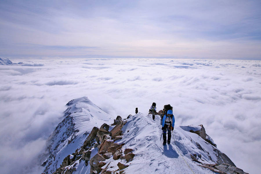 Climbing Group Of Three Men Wallpaper