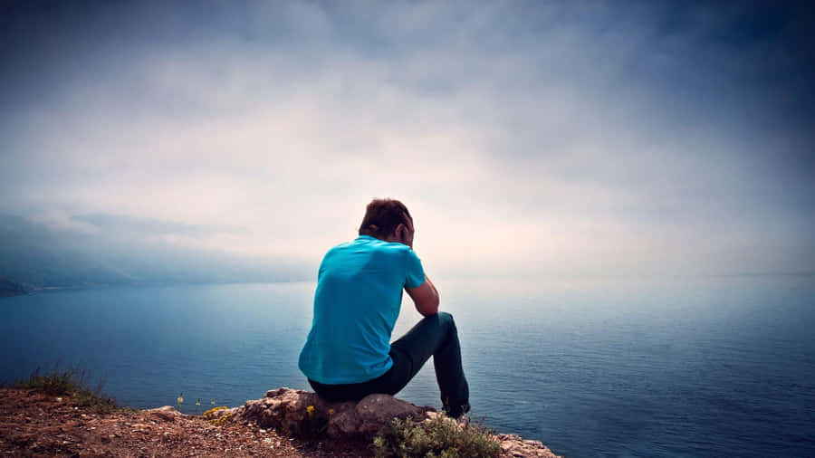 Cool Sad Boy Wearing Blue Shirt Wallpaper