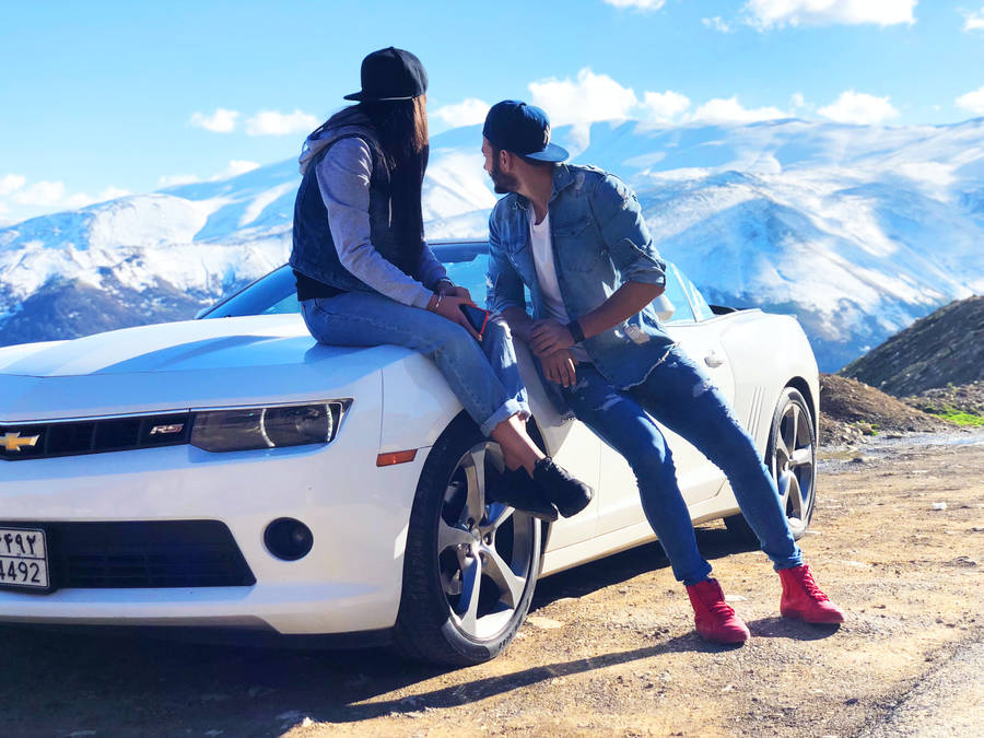 Couple In Love On A White Chevrolet Wallpaper