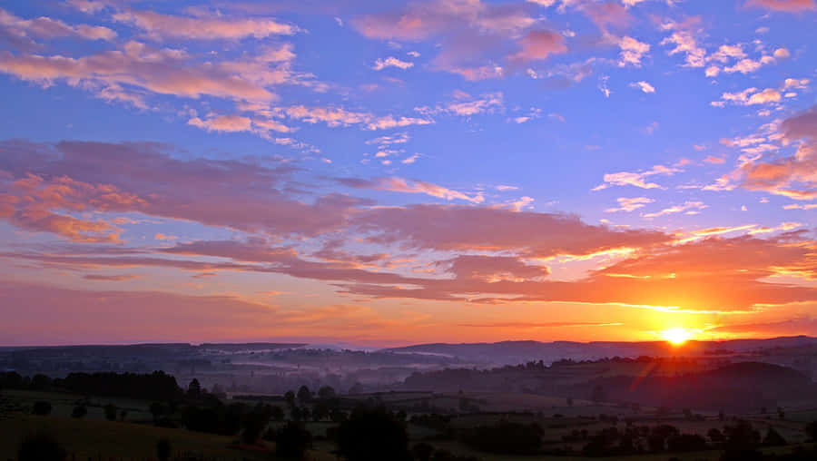 Cute And Cloudy Rural Sunset Wallpaper