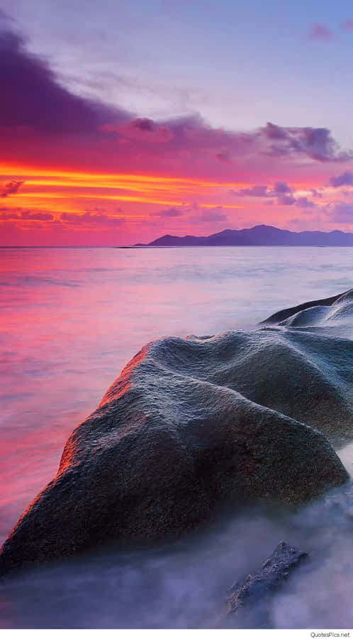 Embrace The Beauty Of Nature With A Sunset Beach View. Wallpaper