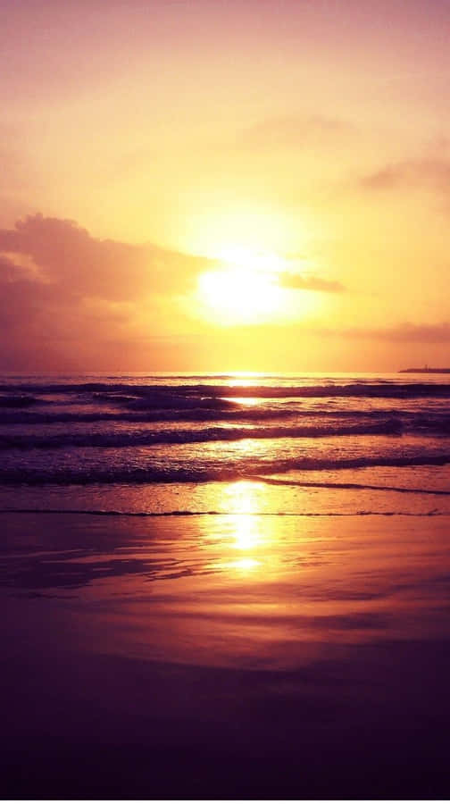 Enjoy The Beauty Of A Stunning Sunset With Your Iphone At The Beach Wallpaper
