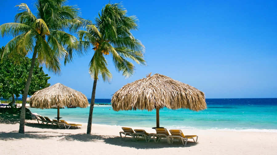 Enjoy The Caribbean Sun On Beautiful Beach Wallpaper