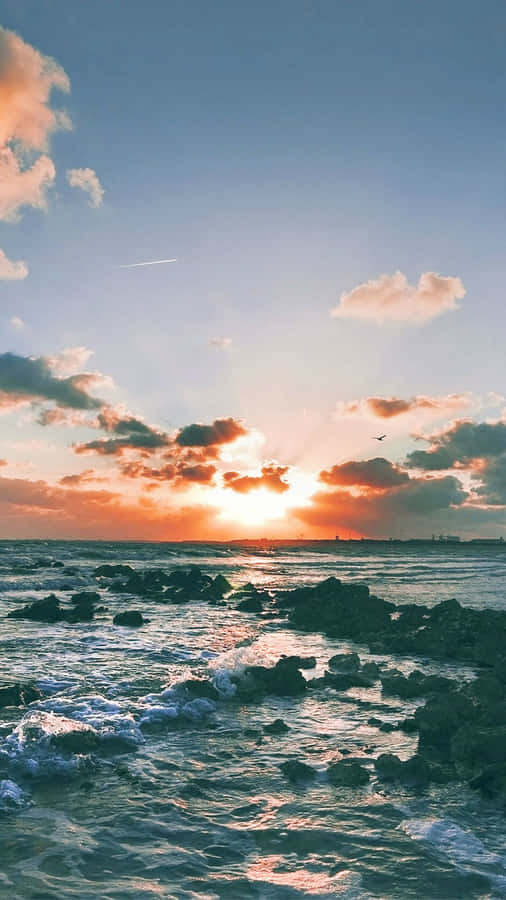 Enjoying A Beautiful Evening Seaside At Sunset Beach Wallpaper