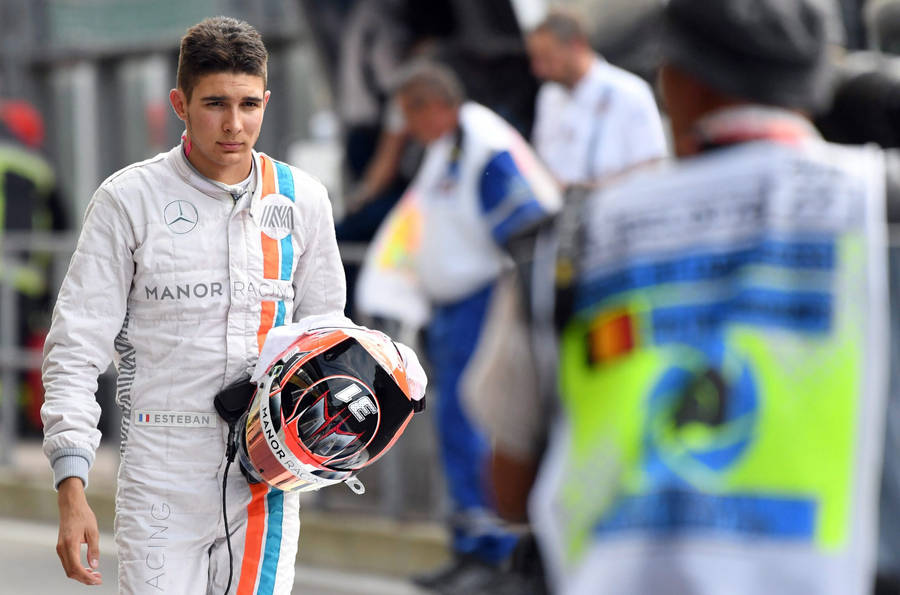 Download Free Esteban Ocon Holding His Racing Helmet During A Racing 